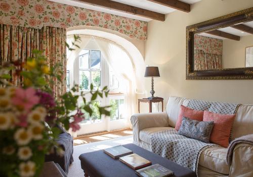 a living room with a couch and a window at Shieldhall - Cabinetmakers Suite in Morpeth