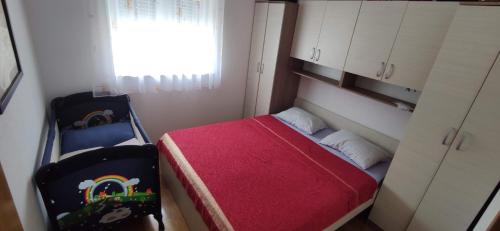 - une petite chambre avec un petit lit et une fenêtre dans l'établissement Apartment Veronika, à Promajna