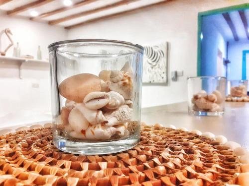 a glass jar filled with mushrooms on a table at Zanzibar Tiny Villa at La Villa De Victor in Matemwe