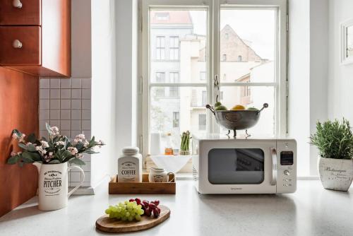 a kitchen with a microwave and a bowl on top of it at Old Town Square Apartment in Prague
