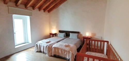 a bedroom with a bed with two lamps on it at Casa da Vila in Castelo de Vide