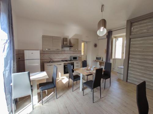 a kitchen and dining room with a table and chairs at Cerva Bianca B&B in Santa Maria Capua Vetere