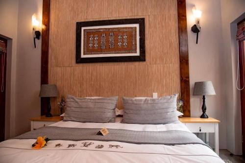 a bedroom with a bed with a stuffed animal on it at Villa Chad Luxury Guesthouse in Kleinmond
