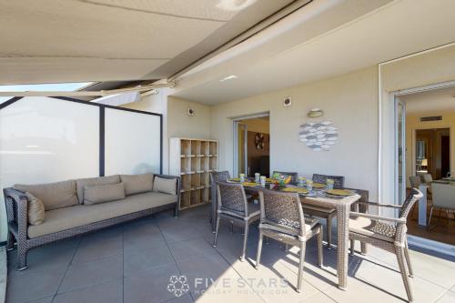 un salon avec un canapé, une table et des chaises dans l'établissement LUXURY BEACH five STARS HOLIDAY HOUSE, à Nice