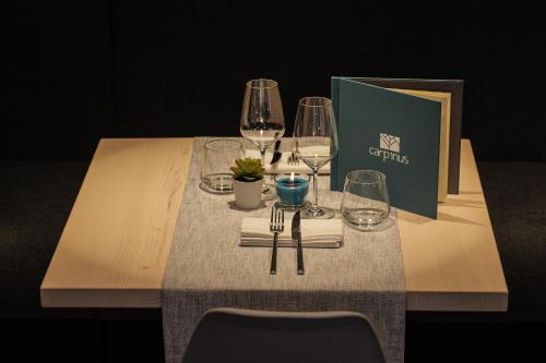 a table with wine glasses and napkins on it at Hotel Milano & Apartments in Miazzina