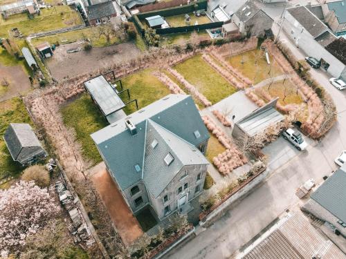 an overhead view of a large house with a yard at La Classe - Former school of the village of Denée in Denée