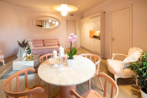a living room with a table and chairs at Redstone Apartments in Rīga