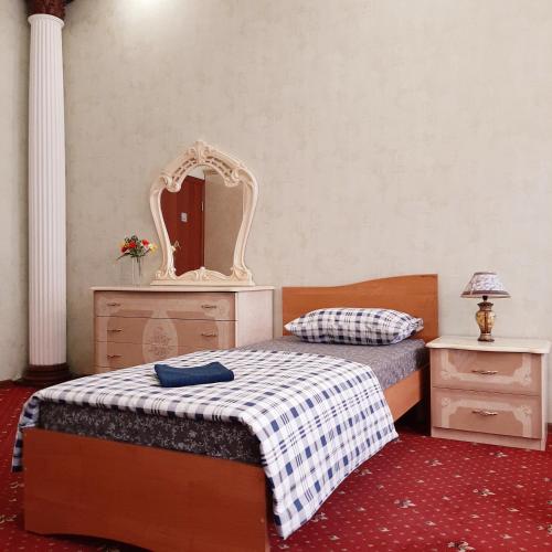 a bedroom with two beds with a mirror and a dresser at Хостел Арбат 29 in Moscow