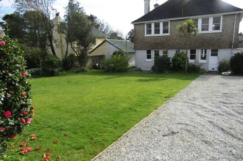 a house with a christmas tree in the yard at Lovely 3 Bed House Close to Carlyon Bay Beach! in Carlyon Bay