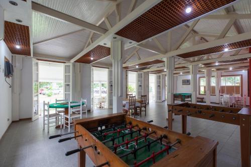 a large room with tables and ping pong tables at Samba Angra dos Reis in Angra dos Reis