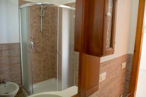 a bathroom with a shower with a toilet and a sink at Villa Maria in San Vito lo Capo