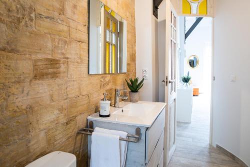 a bathroom with a sink and a mirror at Traditional Valencian Townhouse in Catarroja in Catarroja