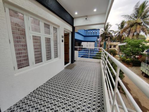 a walkway leading to the balcony of a house at Vogel's Nest in Mysore