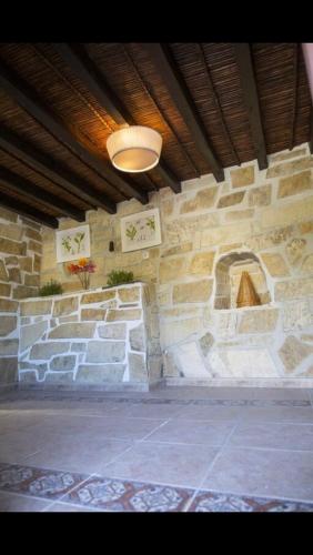 a room with a stone wall with a light at Casa Hector in Granada