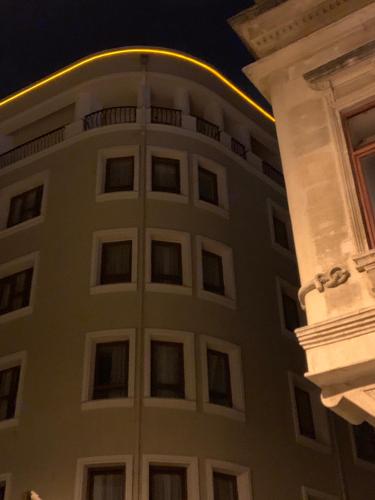 a tall white building with a circle on the side at Grand Sirkeci Hotel in Istanbul