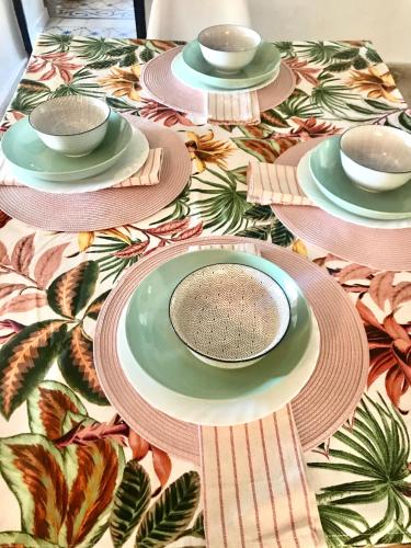a table with plates and bowls on a colorful table cloth at Casa Hector in Granada