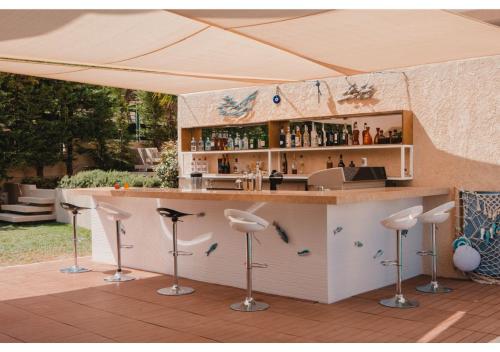 a bar under a tent with stools around it at Blue Note Resort & Club in Athens