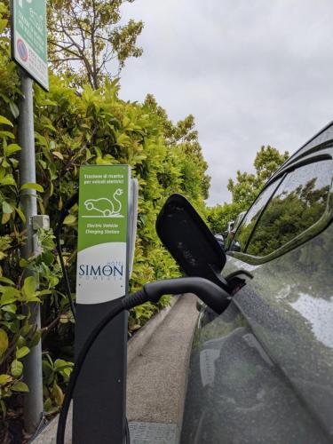 a side view mirror of a car parked on a road at Simon Hotel in Pomezia