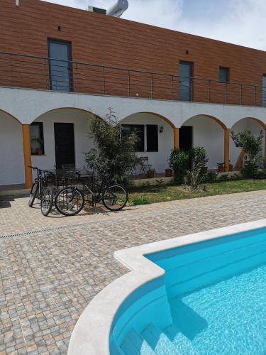 a house with bikes parked next to a swimming pool at Casa das Portas in Azinhaga