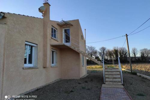 a house with a staircase on the side of it at Casevielle le haut in Tulette