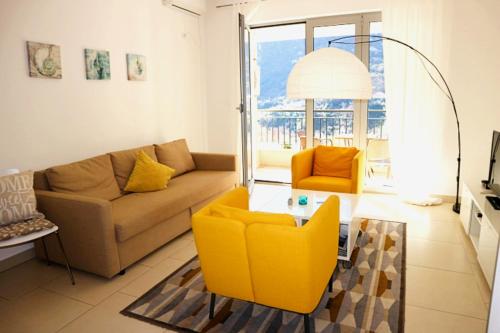 a living room with a couch and a table at Lavender Bay Apartments D3 or D5 I by Andreas Crivellaro in Donji Morinj