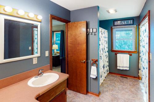 a bathroom with a sink and a mirror at Pirate's Lair #7-F in Frisco