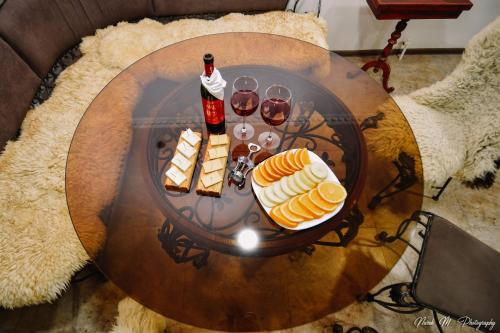 a table with food and glasses of wine on it at Apart Hotel Sayat-Nova in Vanadzor