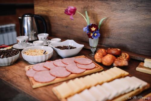 a table topped with cheese and meats and other foods at Apart Hotel Sayat-Nova in Vanadzor