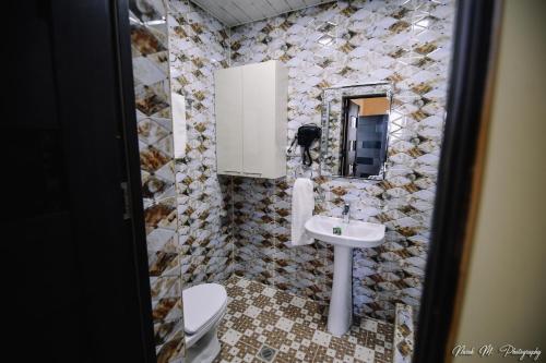 a bathroom with a sink and a toilet at Apart Hotel Sayat-Nova in Vanadzor