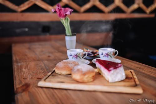 a table with two cups and a plate of food at Apart Hotel Sayat-Nova in Vanadzor
