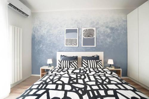 a bedroom with a black and white bed with two lamps at Scandinavian Airy APT in Business Area & Airport in Sofia