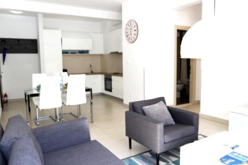 a living room with a couch and chairs and a table at Lavender Bay Apartments D3 or D5 I by Andreas Crivellaro in Donji Morinj