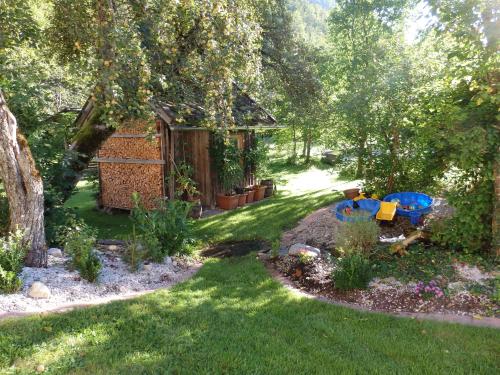 a backyard with a garden with a play structure at Sportlerhof - Alimann UaB in Grünau im Almtal