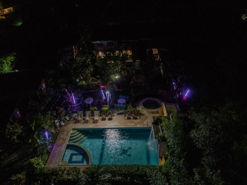 an overhead view of a swimming pool at night at Mindo GlamBird Glamping & Lodge in Mindo