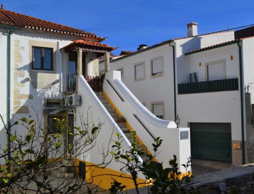 a white house with a slide in front of it at Yasmine 212 in Ançã