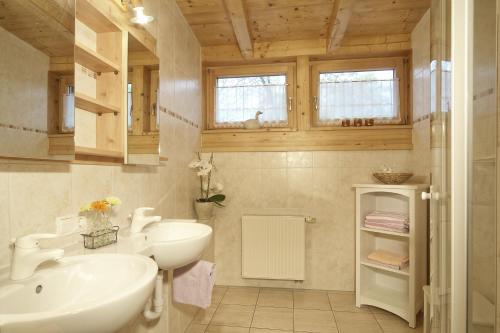 a bathroom with a sink and a toilet and a mirror at Landhaus Eschenbach in Schönau am Königssee