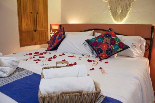 a bed with rose petals laying on it at Puerta San Pedro in Guadalajara