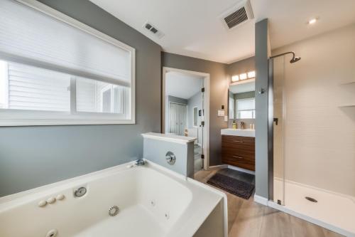 a bathroom with a large tub and a window at Tiffanie By The Sea in Ocean City