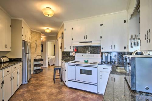 a kitchen with white cabinets and white appliances at Quiet Lakefront Retreat with Boat Ramp and 2 Docks in Hollywood Point