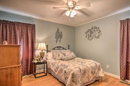 a bedroom with a bed and a ceiling fan at Quiet Lakefront Retreat with Boat Ramp and 2 Docks in Hollywood Point