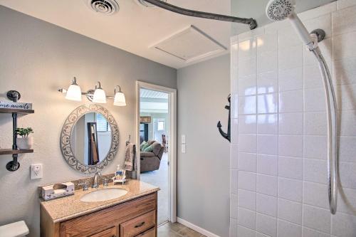 a bathroom with a shower and a sink and a mirror at Updated Afton Cottage with Dock and Lake Access! in Afton