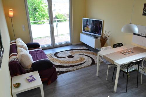 a living room with a couch and a table at Loft Apartments Pulheim in Pulheim