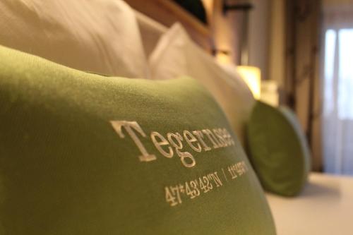 a close up of a green couch with the words i expectruck at Seehotel zur Post in Tegernsee