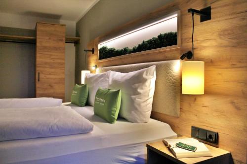 a hotel room with a bed and a window at Seehotel zur Post in Tegernsee