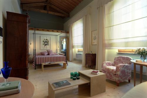a living room with a couch and a chair at Fattoria Casamora - Suites in Pian di Scò