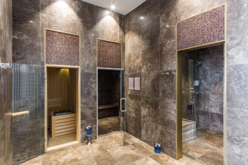 a bathroom with a shower and a walk in shower at Radisson Collection Hotel Bamako in Bamako