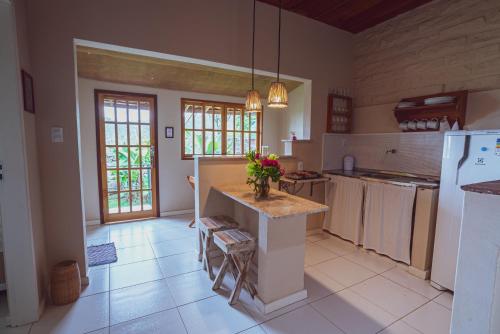 a kitchen with a island in the middle of a room at Pousada Pedras de Igatu in Igatu