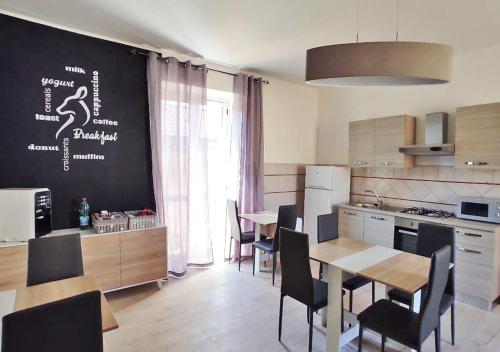 a kitchen with a table and chairs in a kitchen at Cerva Bianca B&B in Santa Maria Capua Vetere