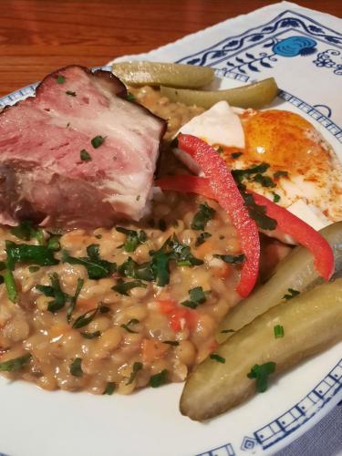 a plate of food with meat and beans and vegetables at Hotel U Beránků in Libochovice