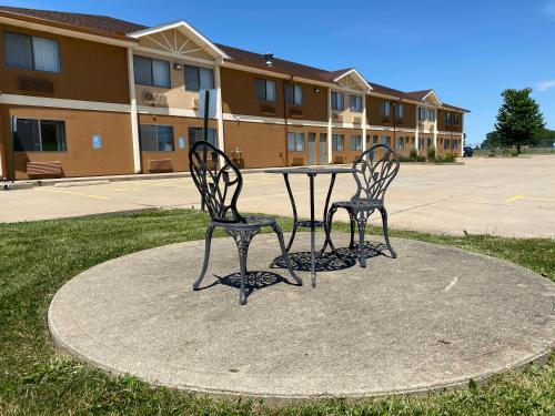 two chairs sitting at a table in front of a building at Quality Inn Morton at I-74 in Morton